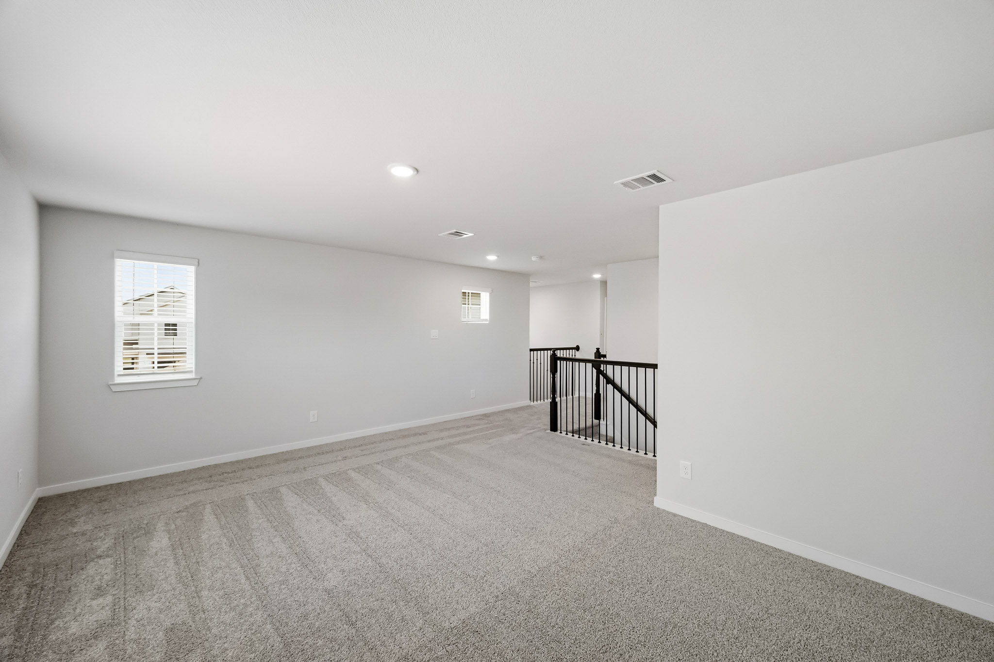 A hallway with a railing.