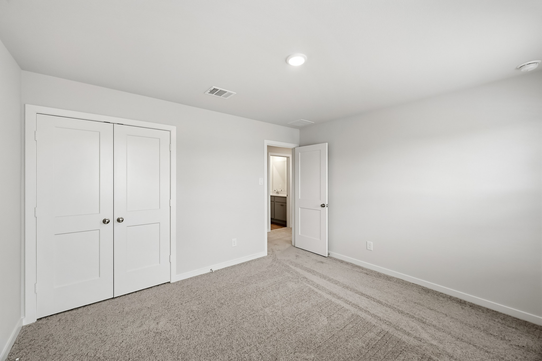 A hallway with white doors.