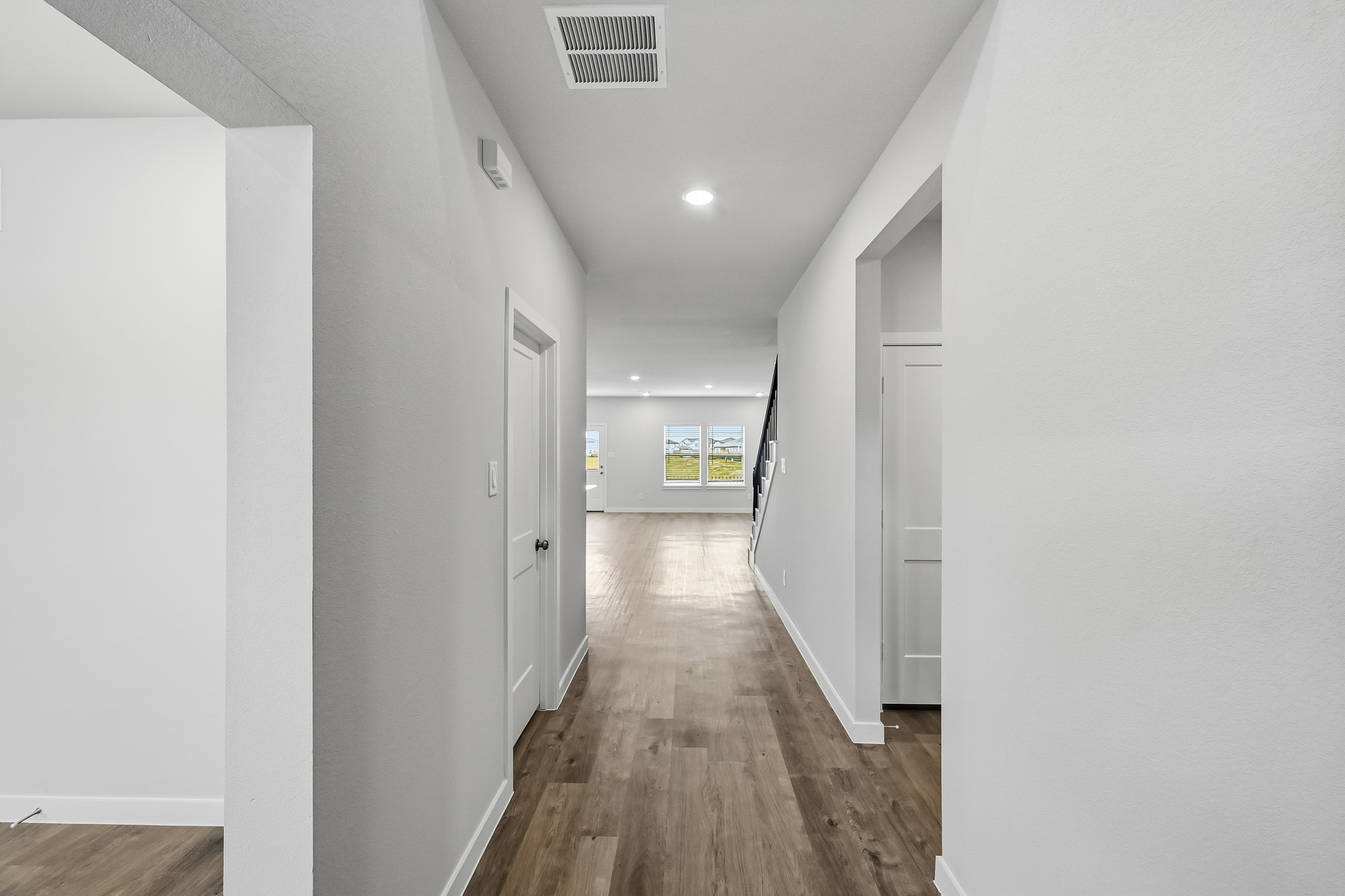 A hallway with white walls.