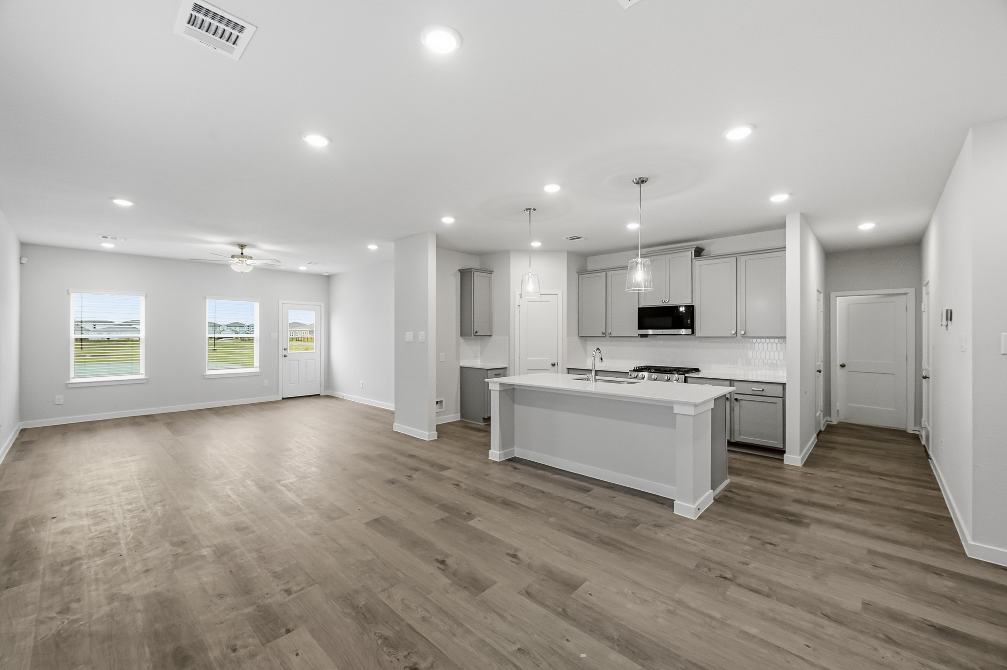 A kitchen with white cabinets.