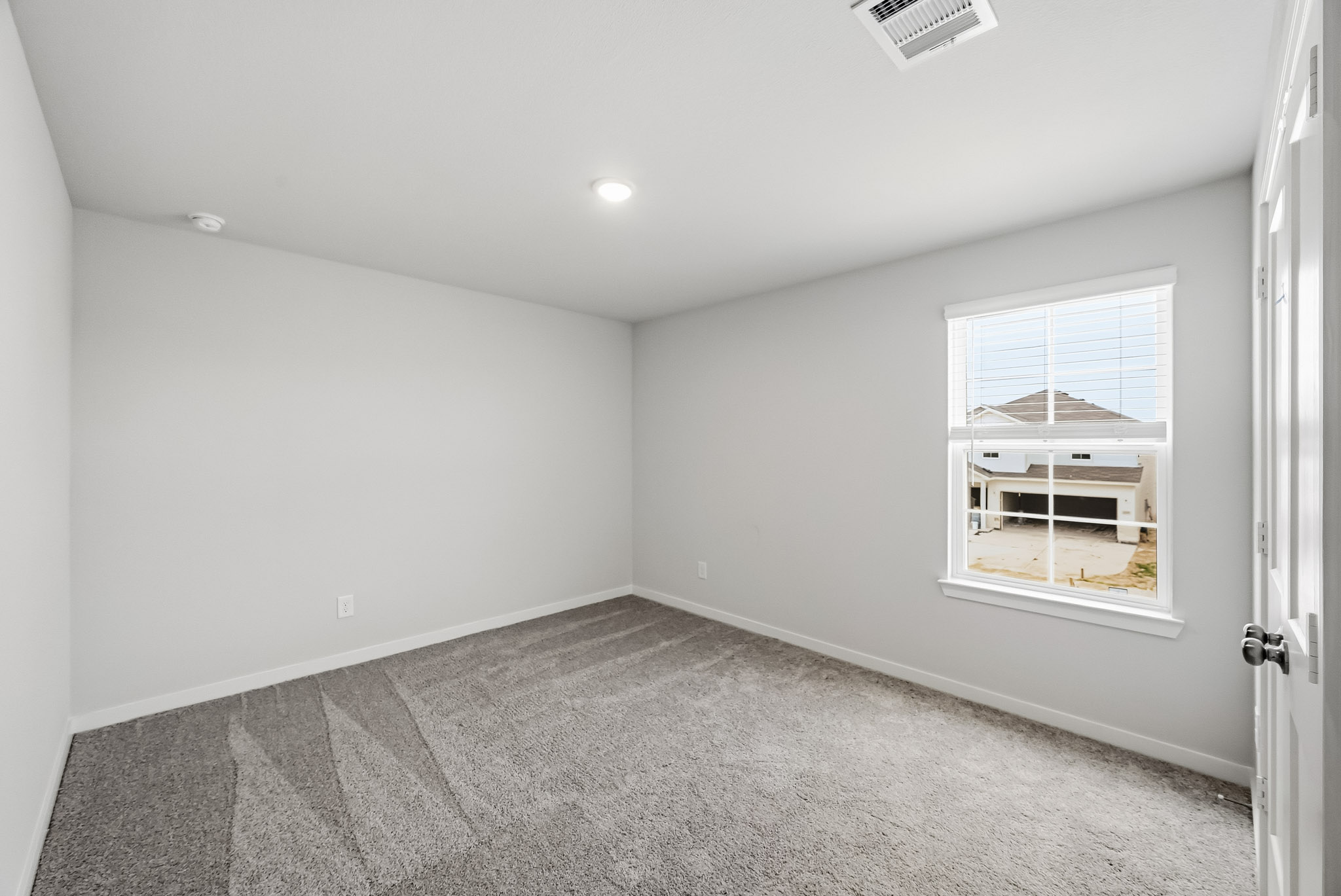 A room with a window and a door.