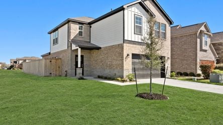 A large house with a green lawn.