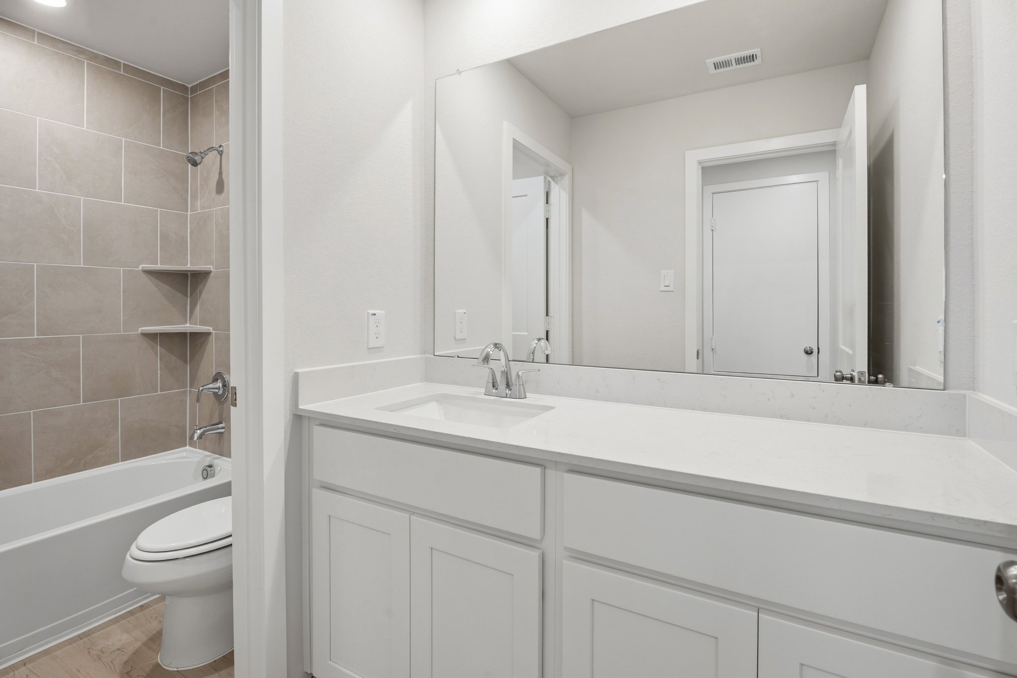 A bathroom with a tub sink and toilet.