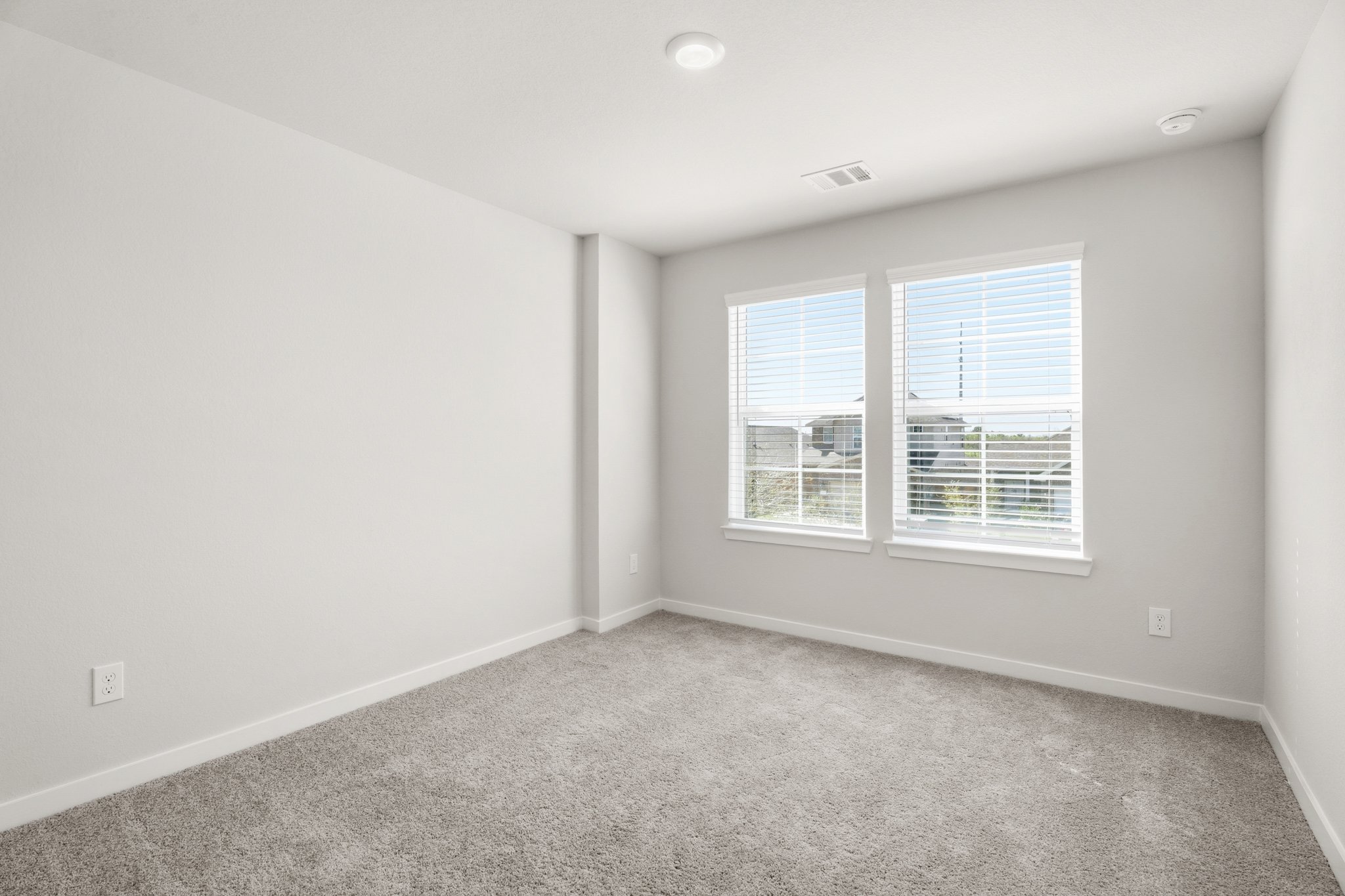 A room with a window and a carpet.