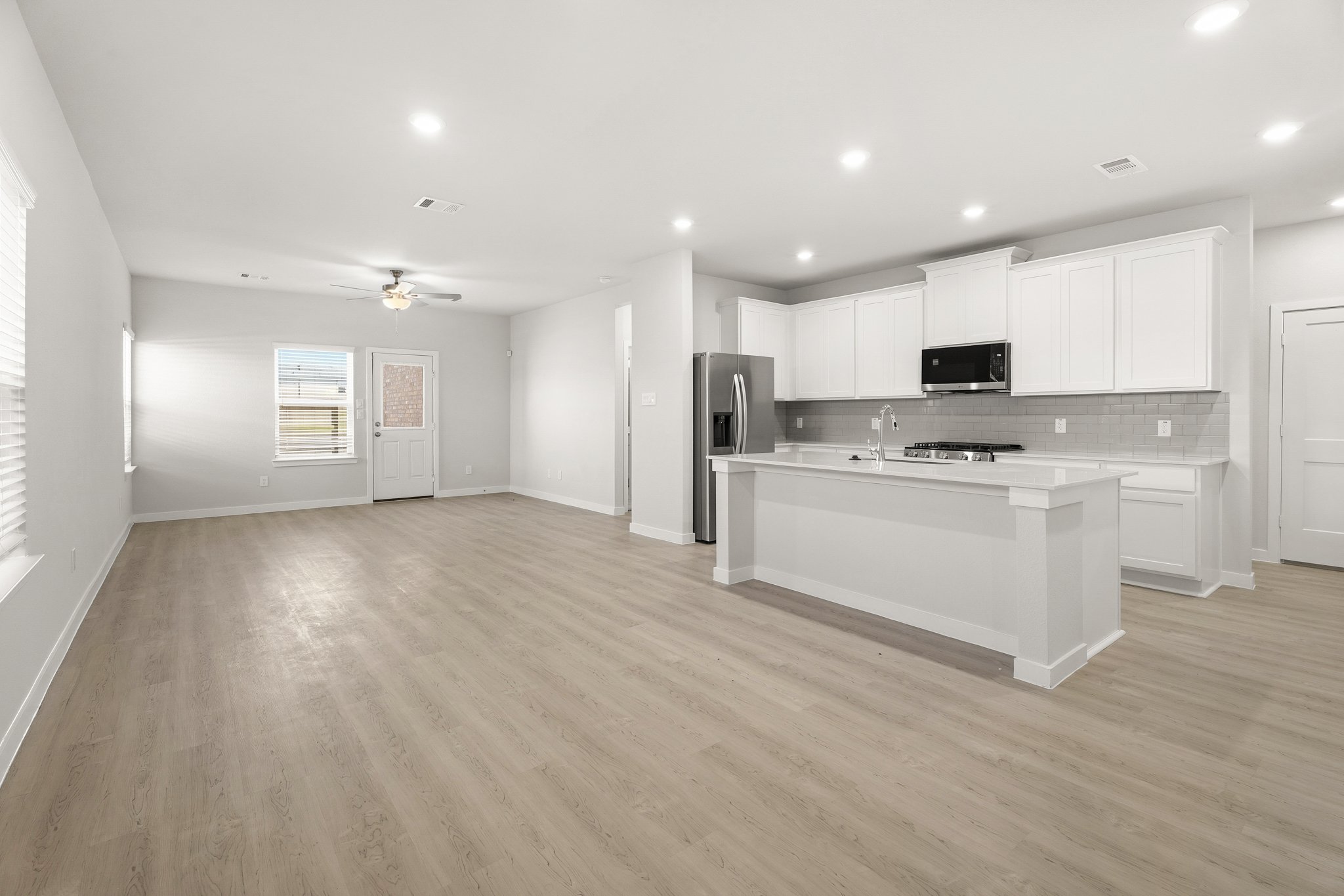 A kitchen with white cabinets.