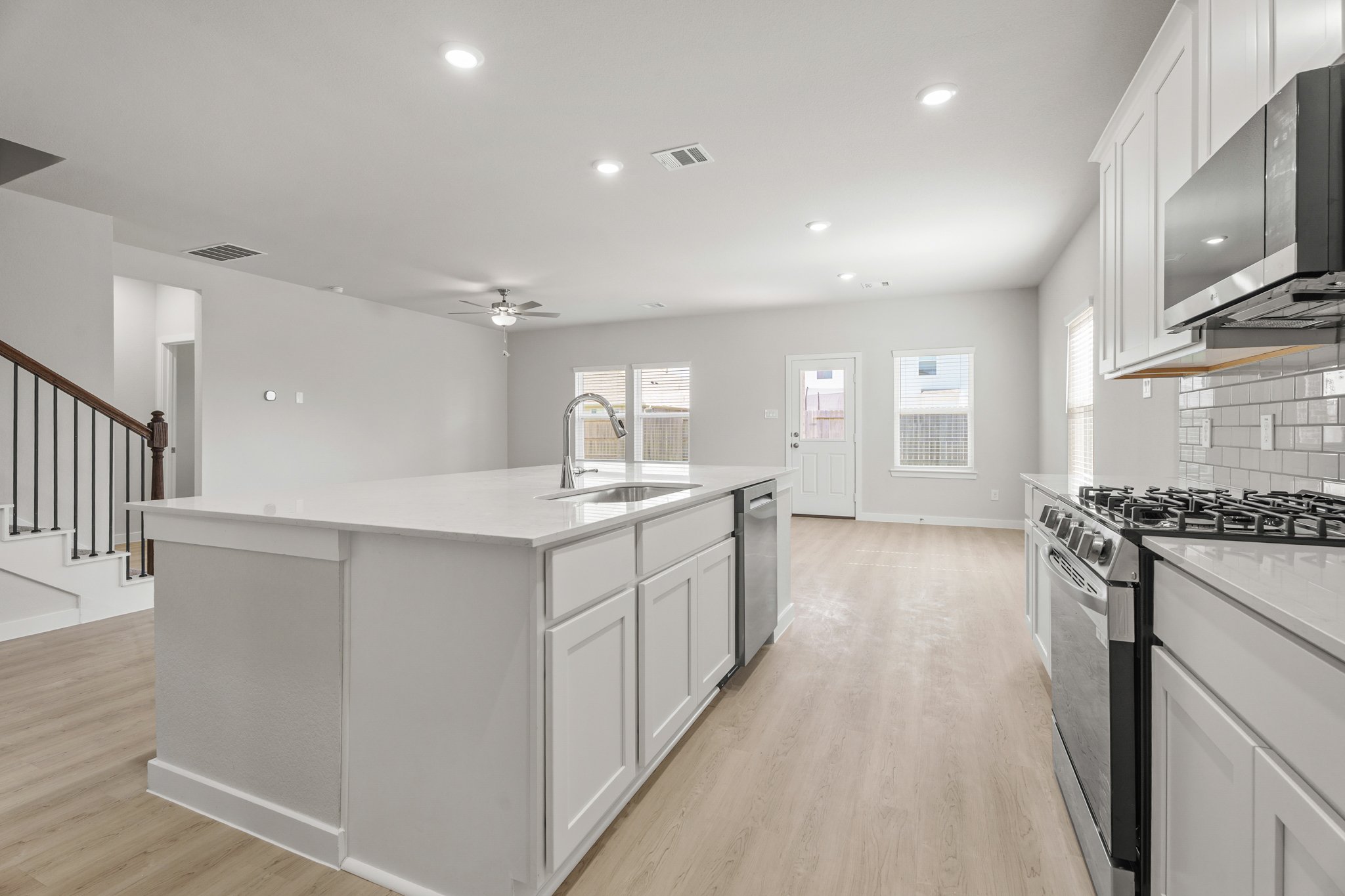 A kitchen with white cabinets.