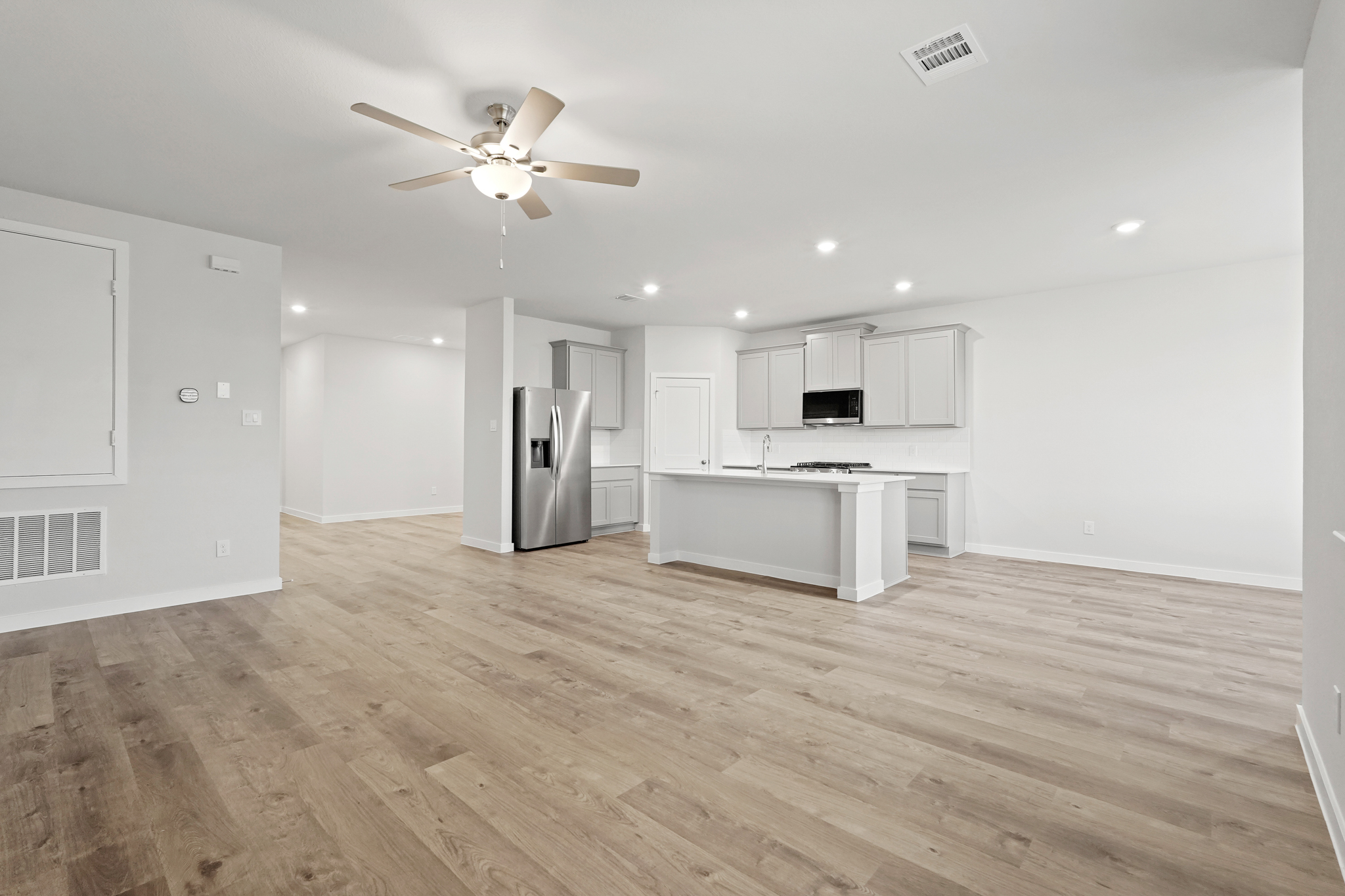 A large kitchen with white cabinets.