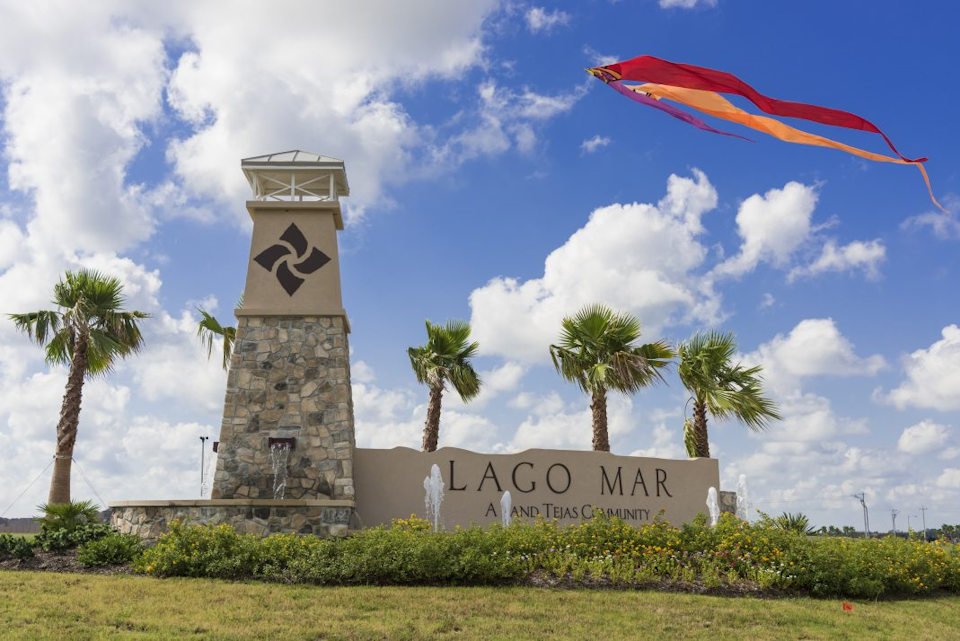 A sign with a kite flying over it.