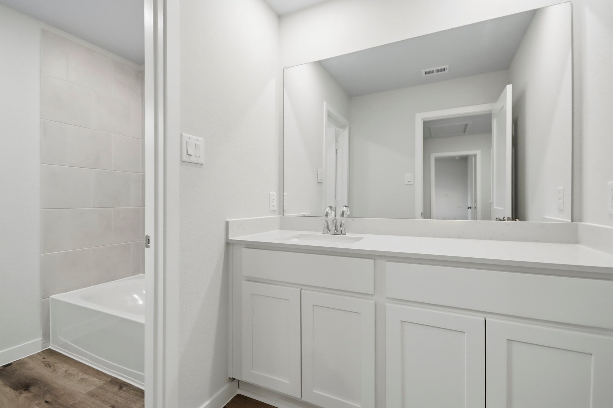 A bathroom with a sink and a tub.