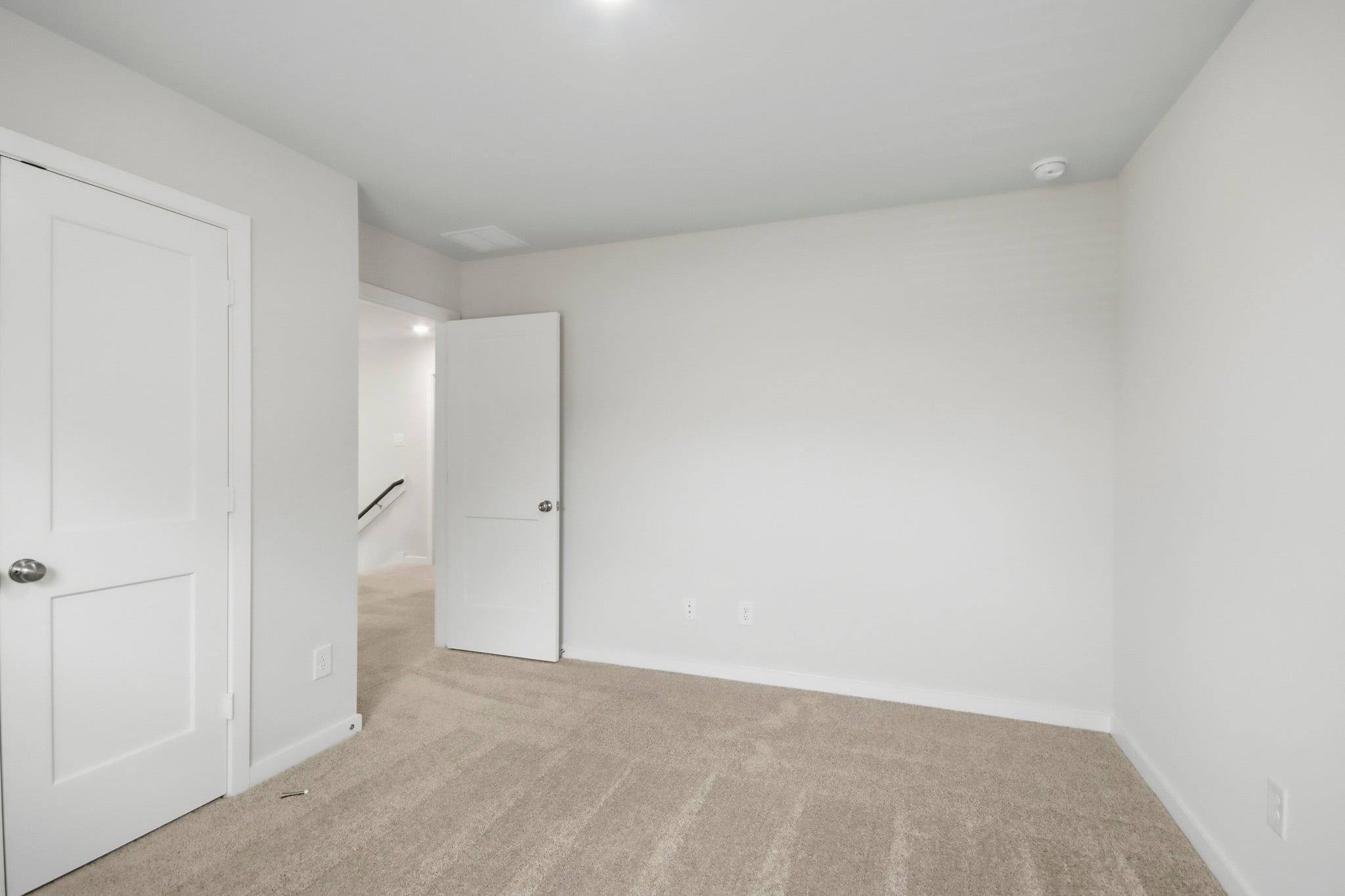 A hallway with white doors.