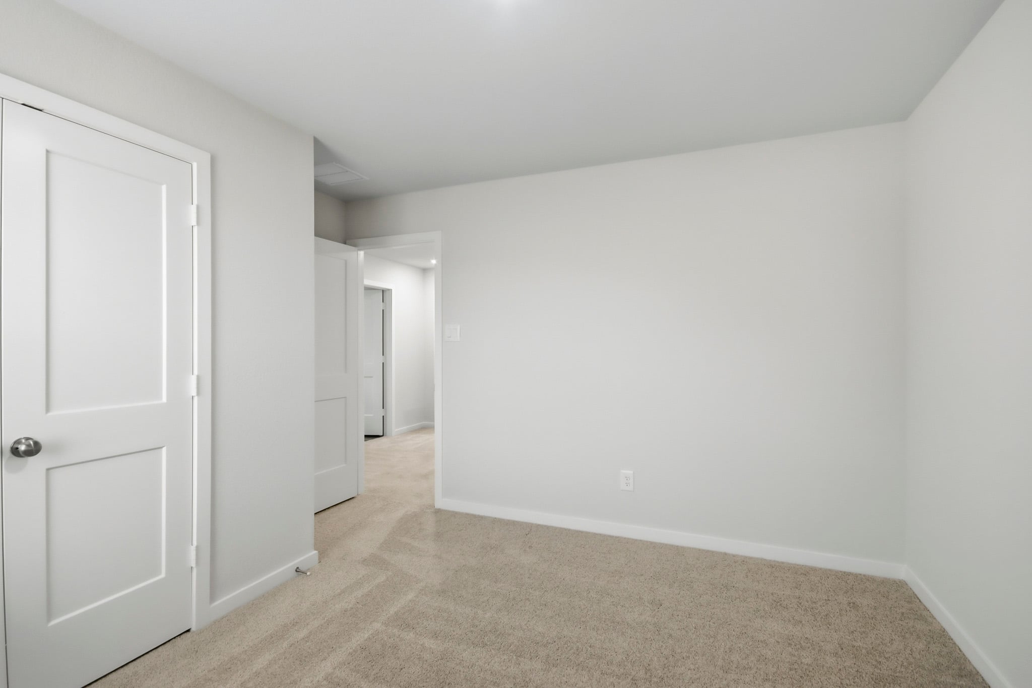 A hallway with white doors.