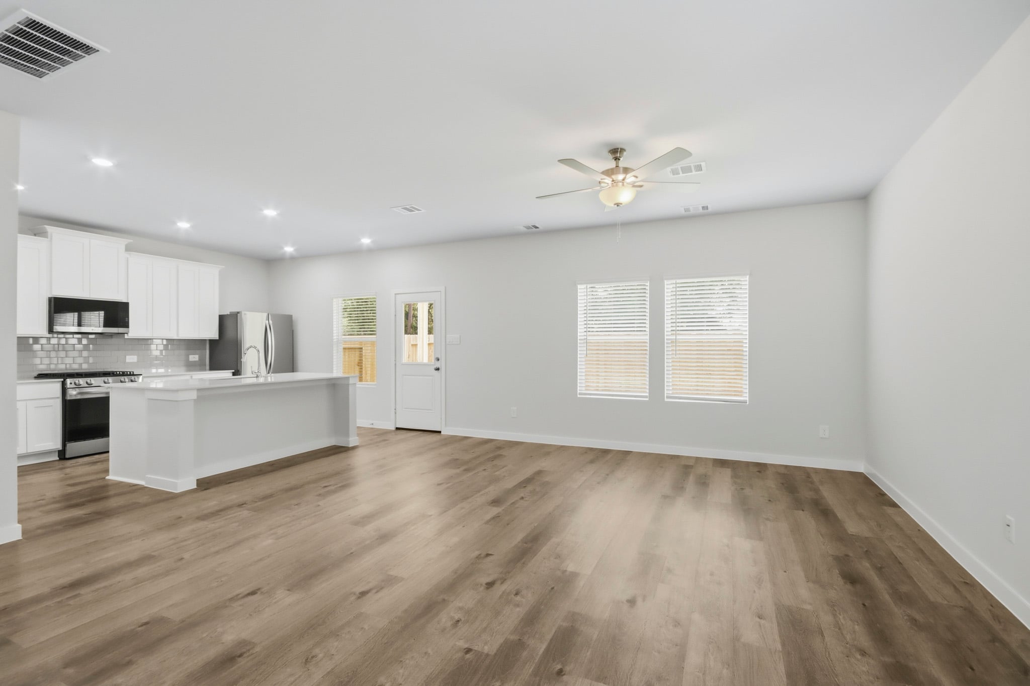 A kitchen with white cabinets.