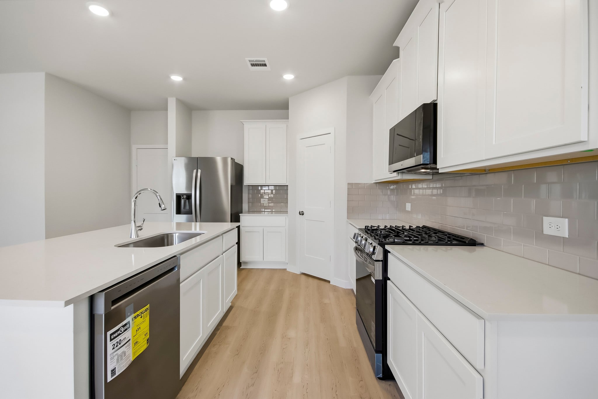 A kitchen with white cabinets.