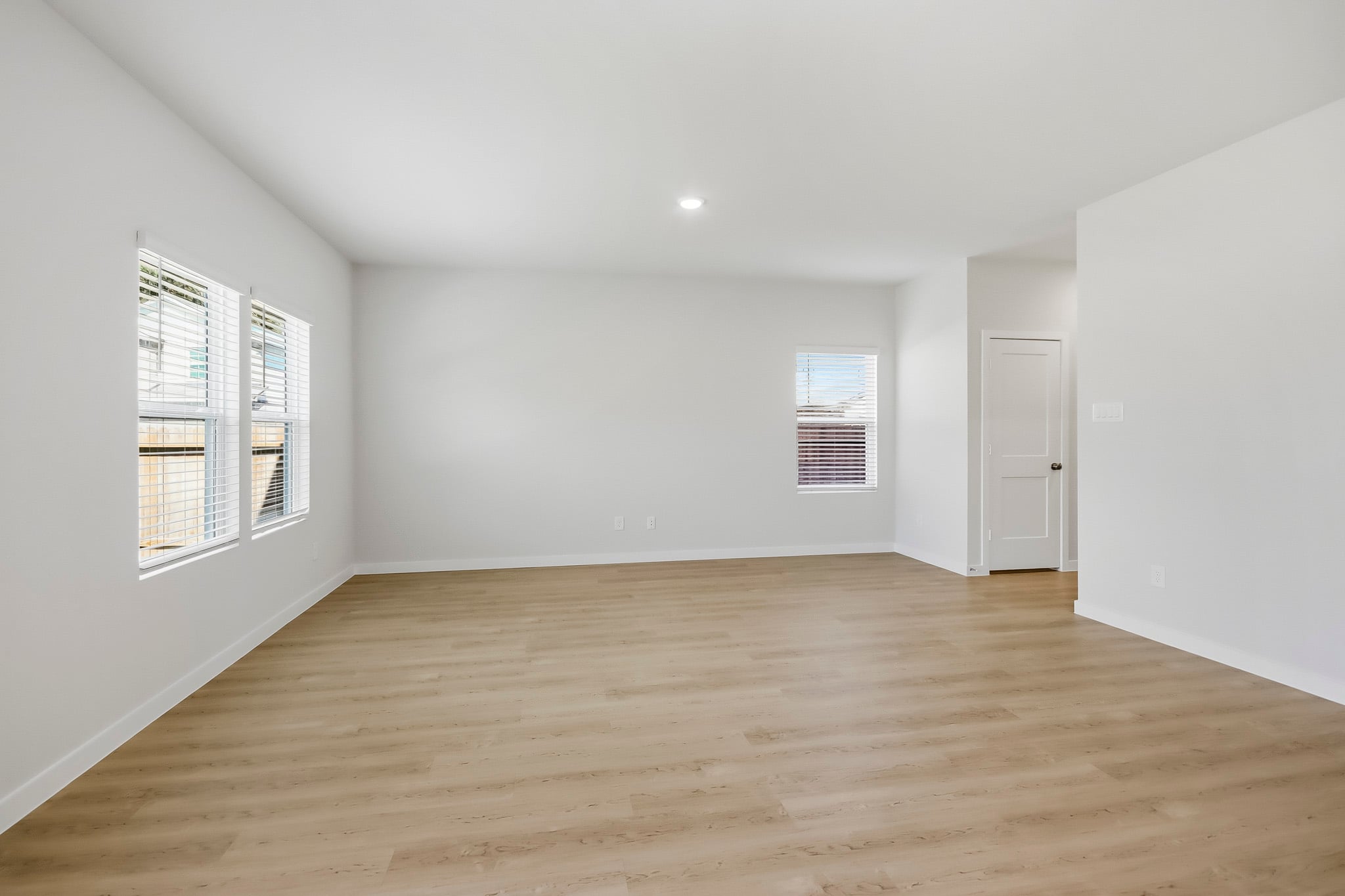 A room with a wood floor and white walls.