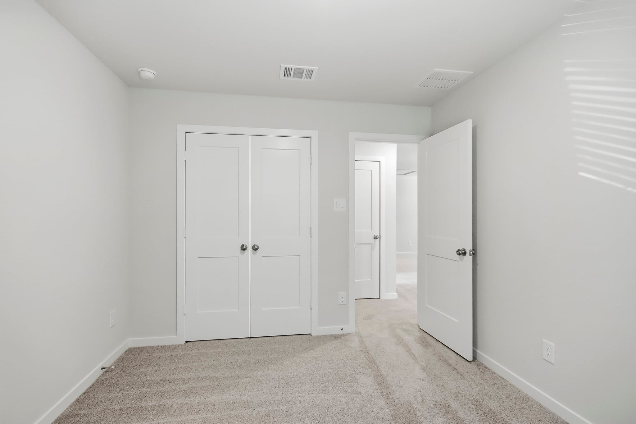 A hallway with white doors.