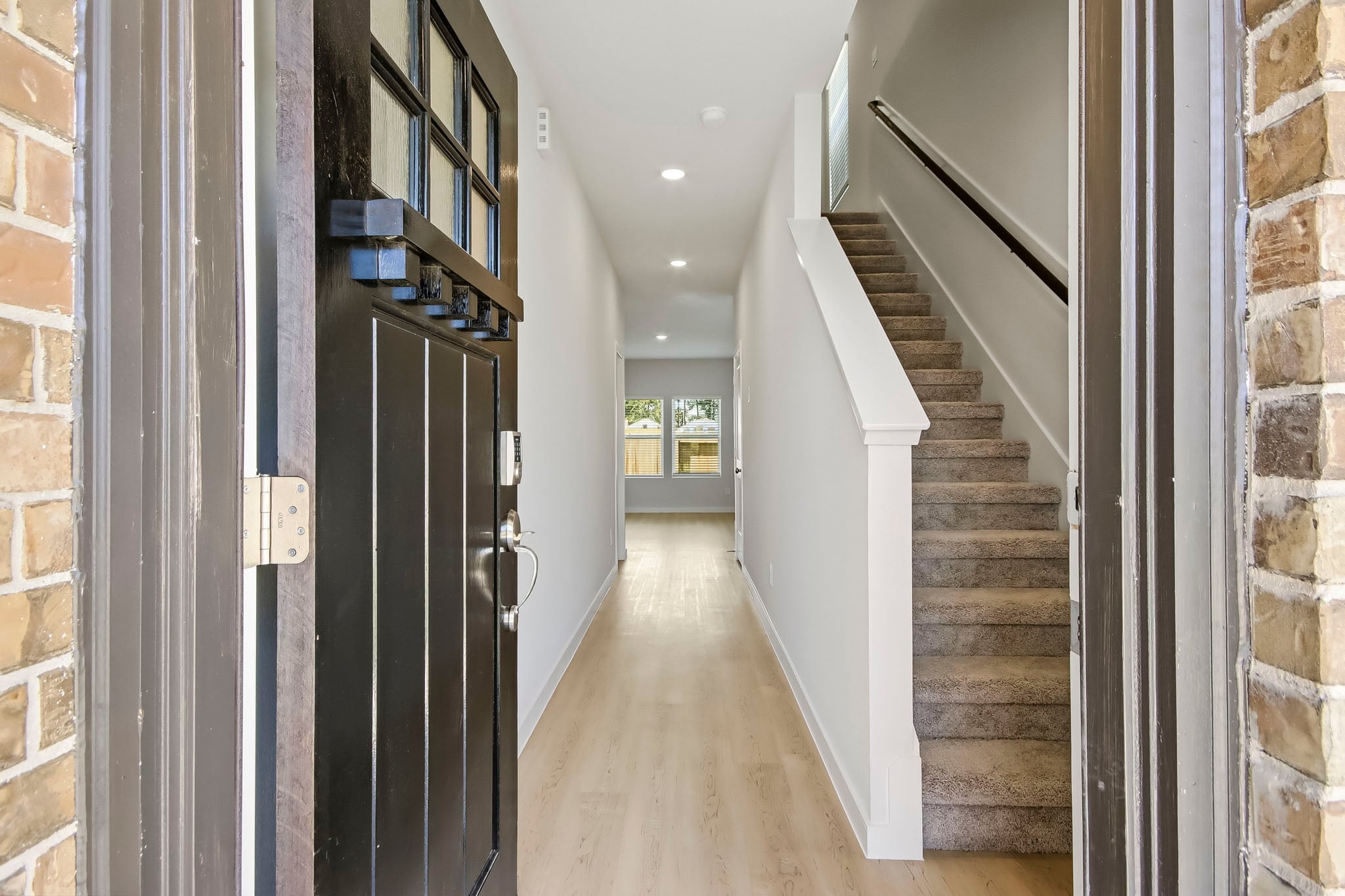A hallway with a staircase.