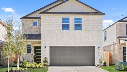 A grey house with a garage.