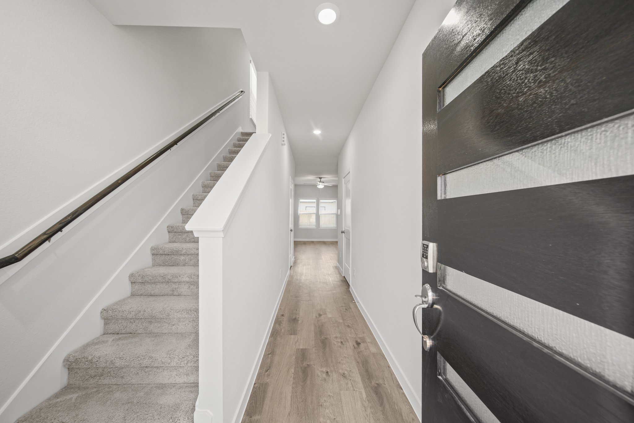 A long hallway with white walls.
