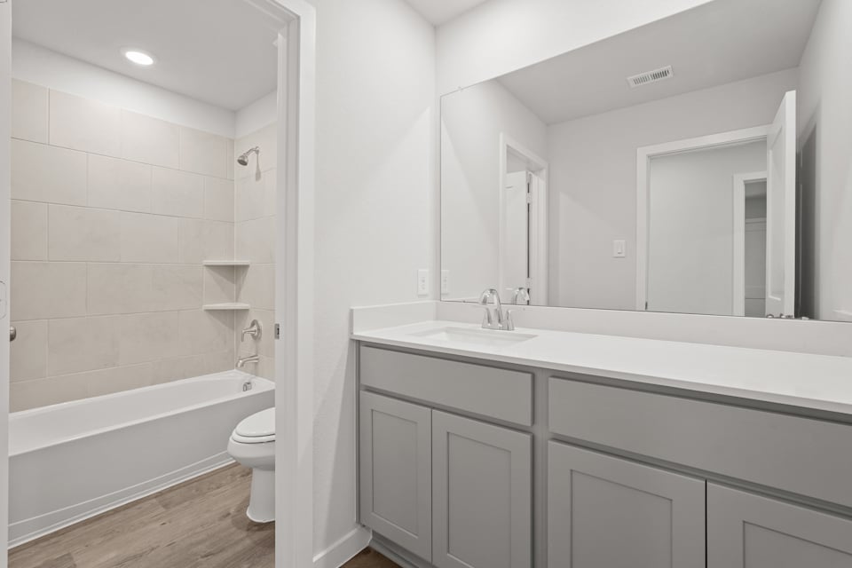 A bathroom with a tub sink and toilet.