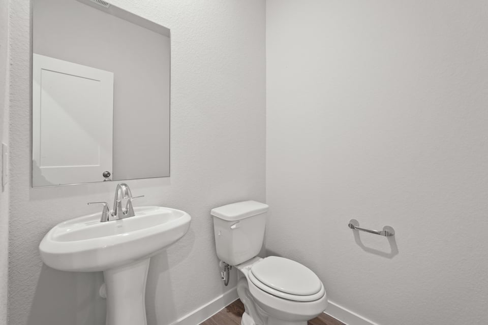A bathroom with a toilet and sink.