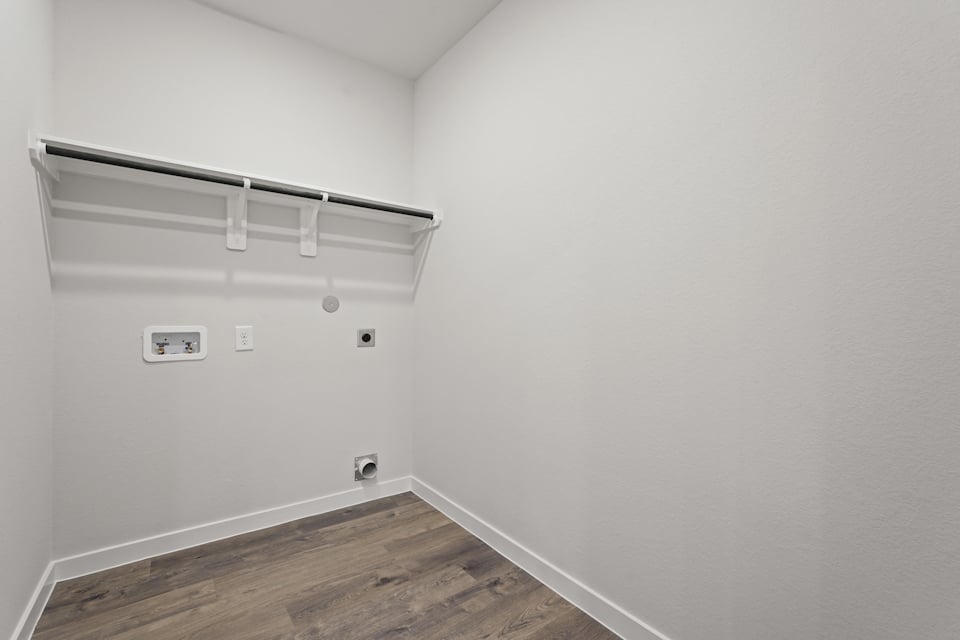 A white wall with a light fixture.