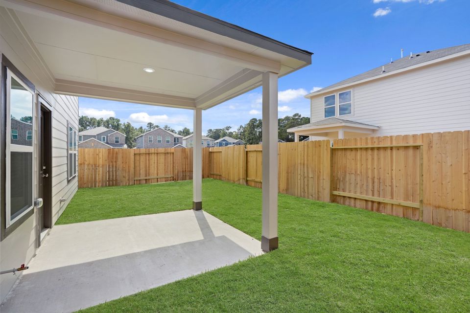 A backyard with a fence and a wood fence.