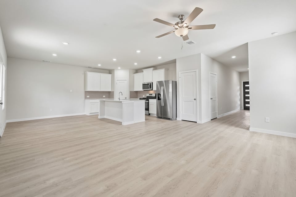 A kitchen with white cabinets.