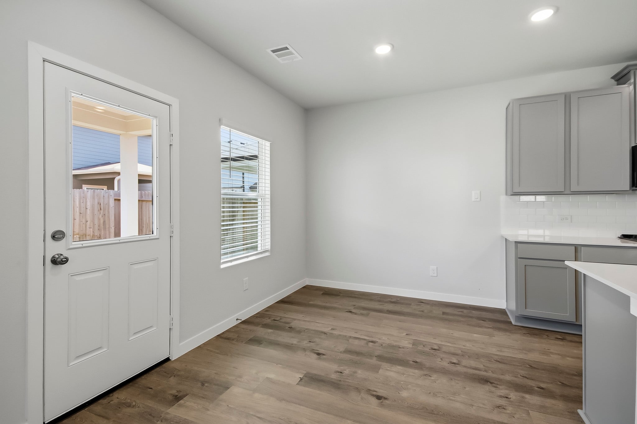 A room with white cabinets.