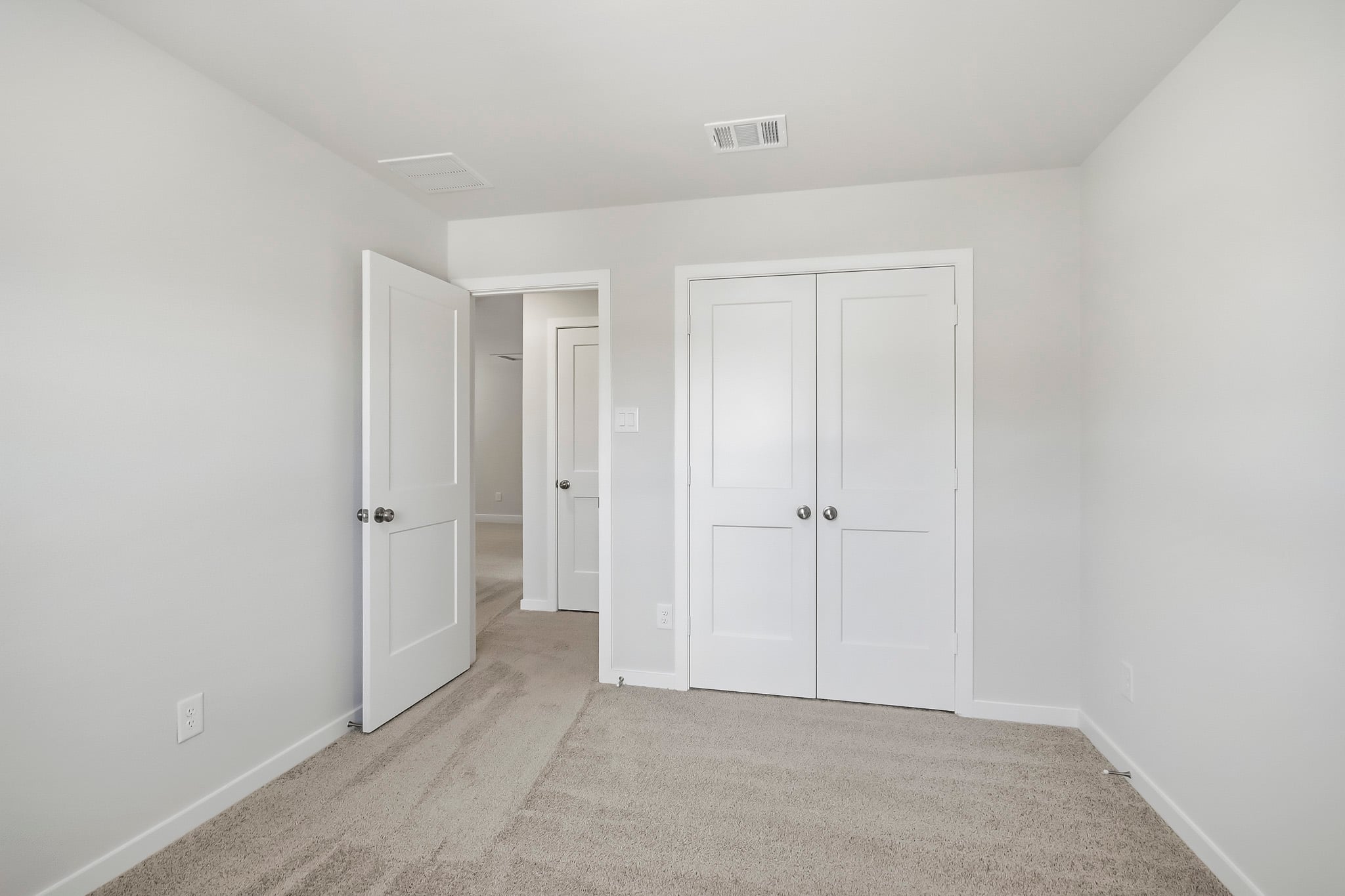 A hallway with white doors.