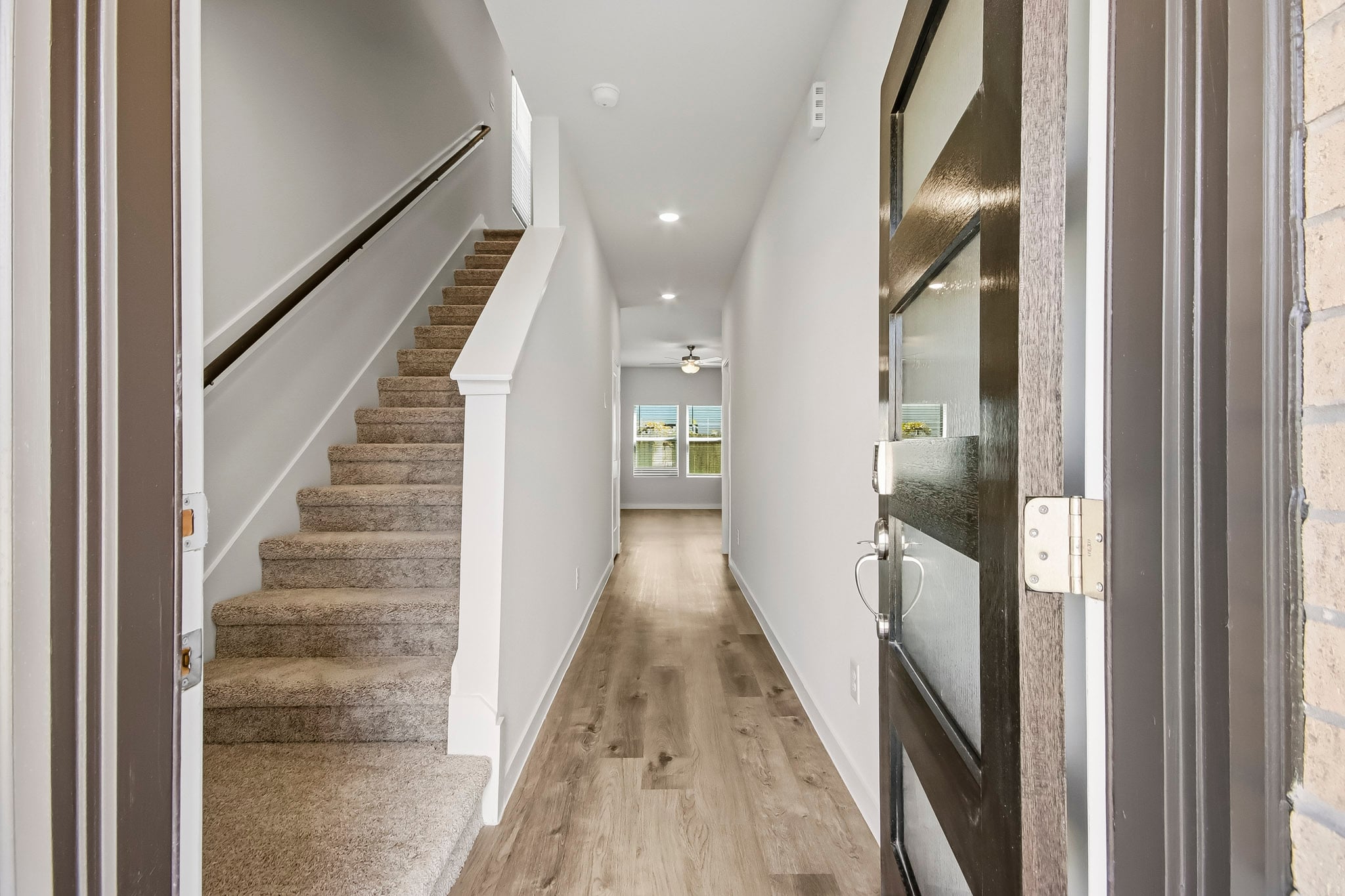 A long hallway with white walls.
