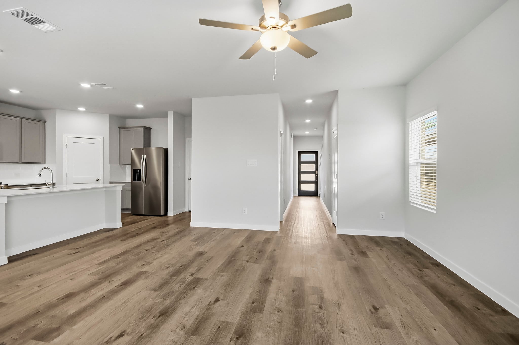 A kitchen with a wood floor.