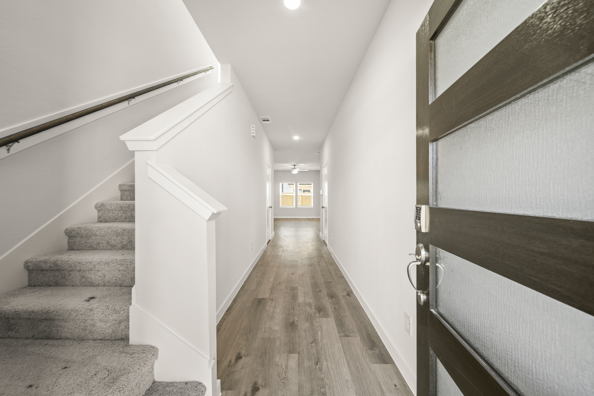 A hallway with white walls.