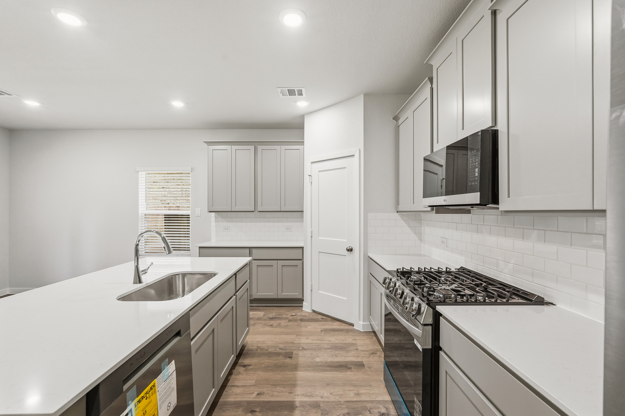 A kitchen with white cabinets.