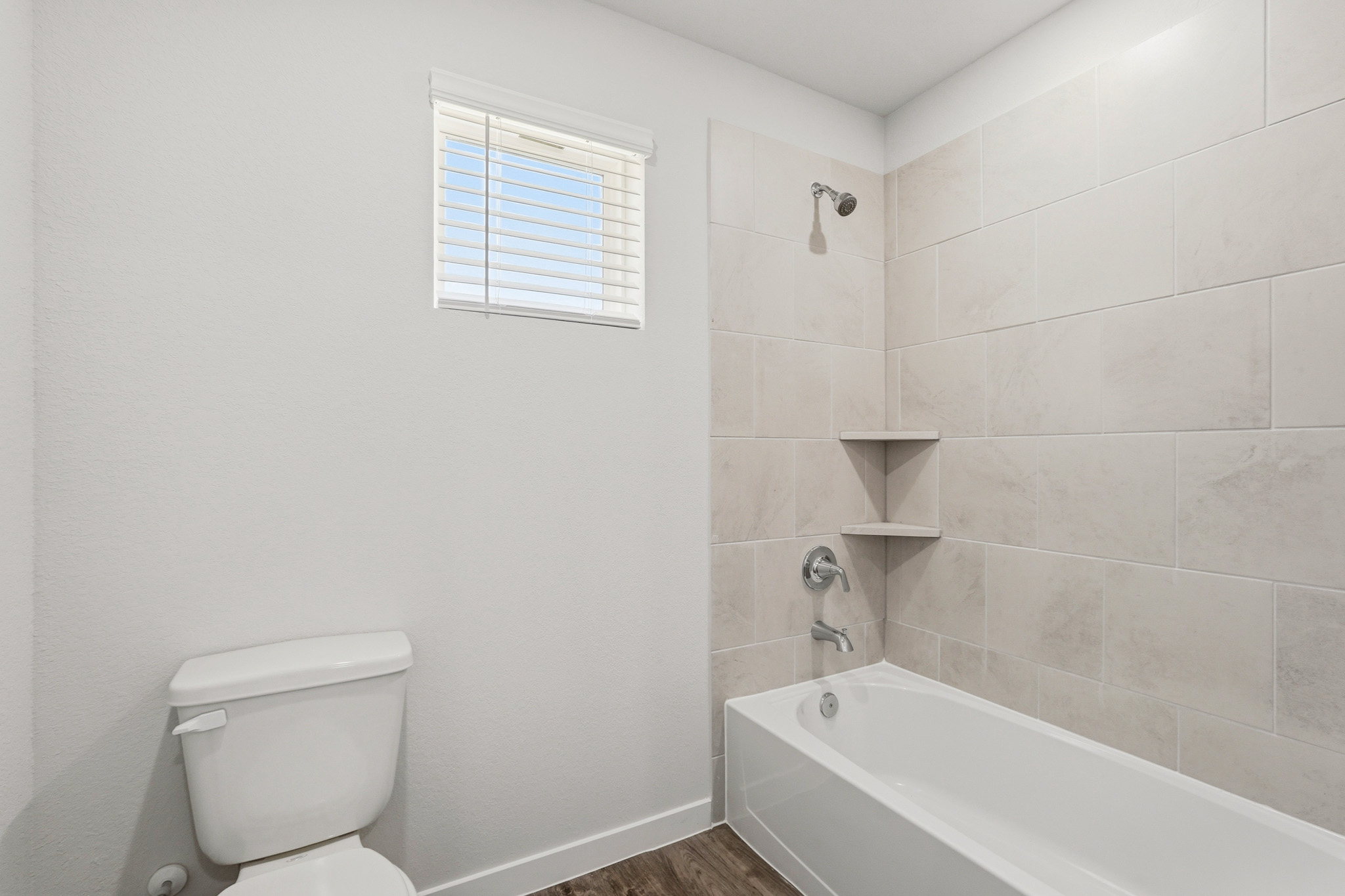 A bathroom with a tub toilet and sink.