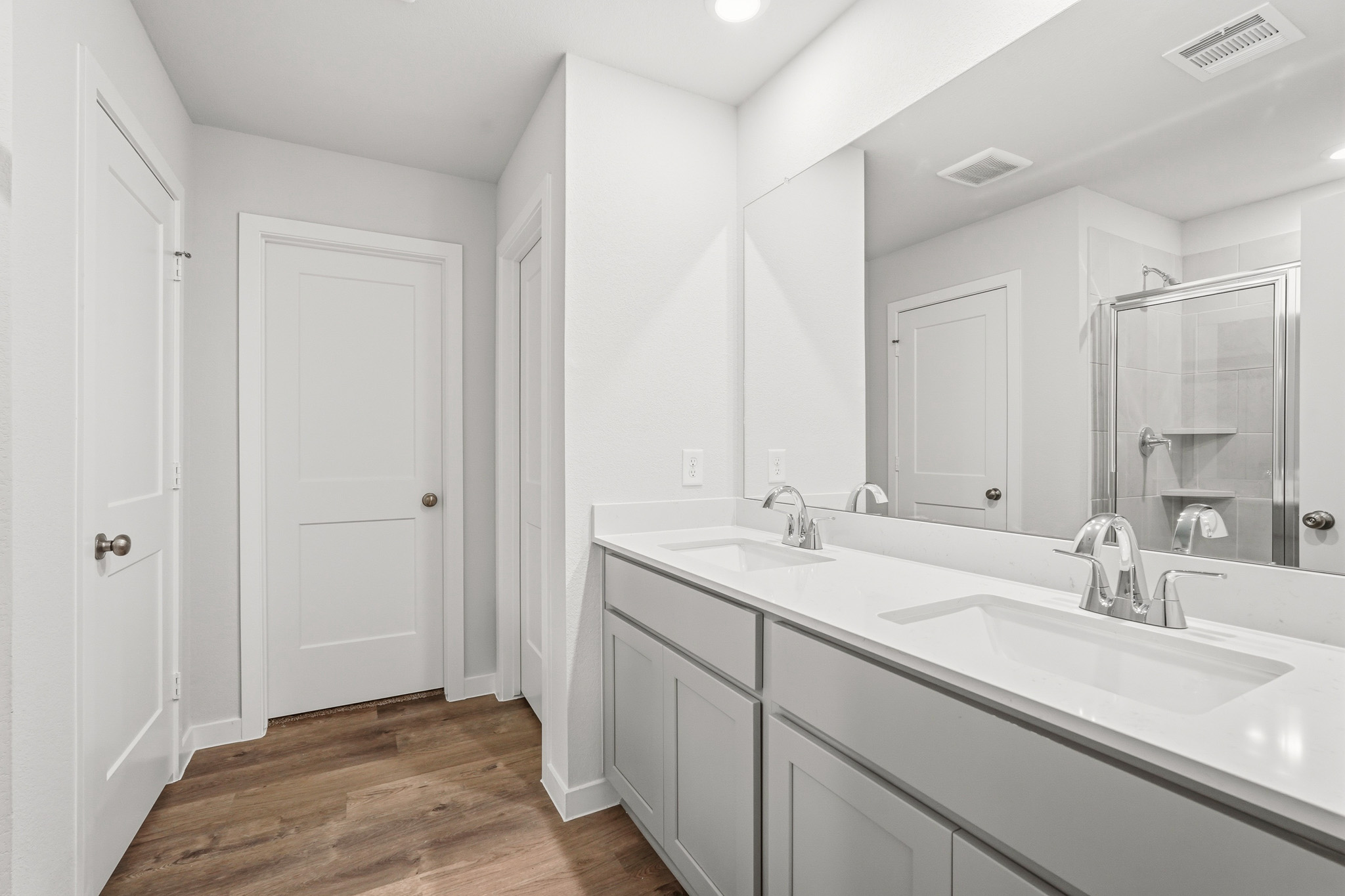 A bathroom with a large mirror.
