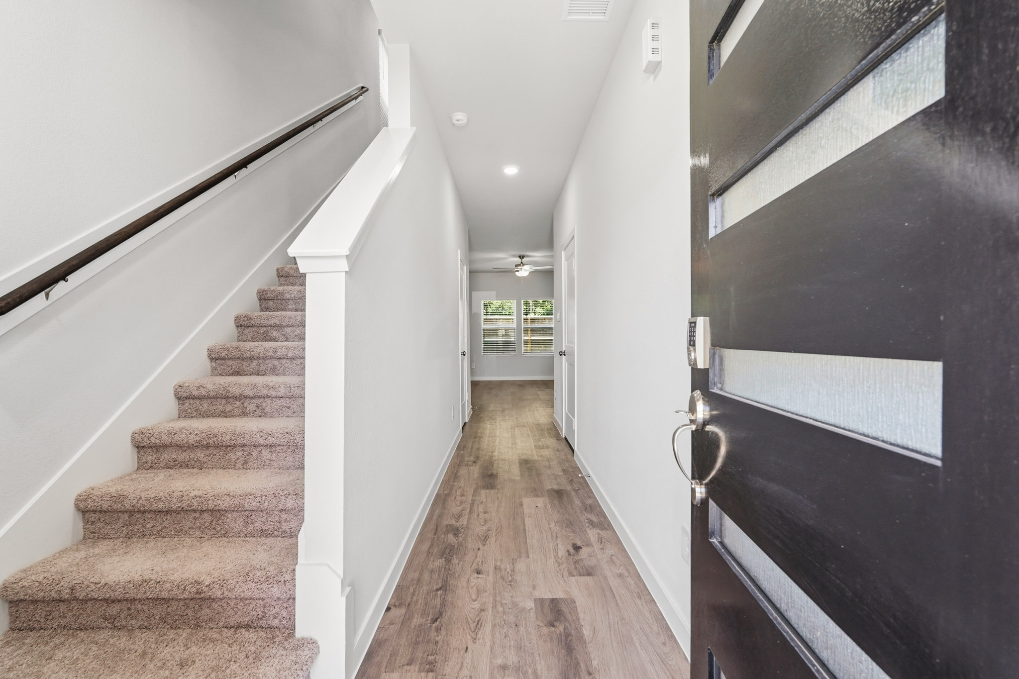 A hallway with white walls.