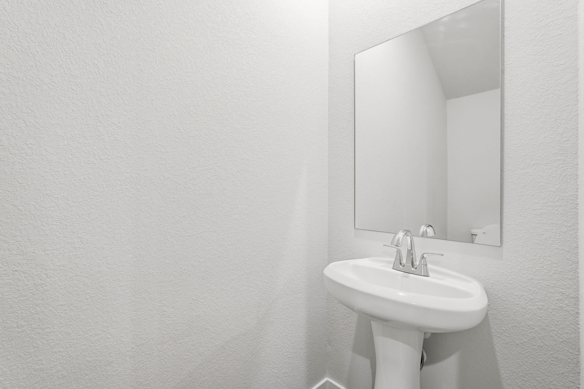A bathroom with a large mirror.