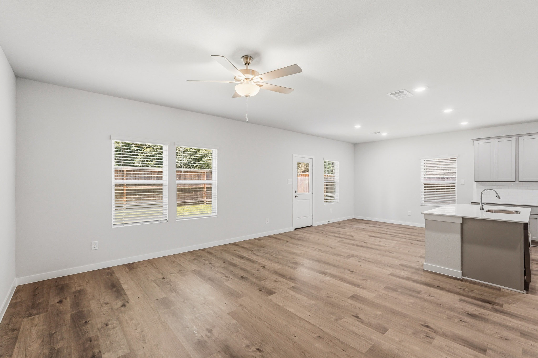 A kitchen with a wood floor.