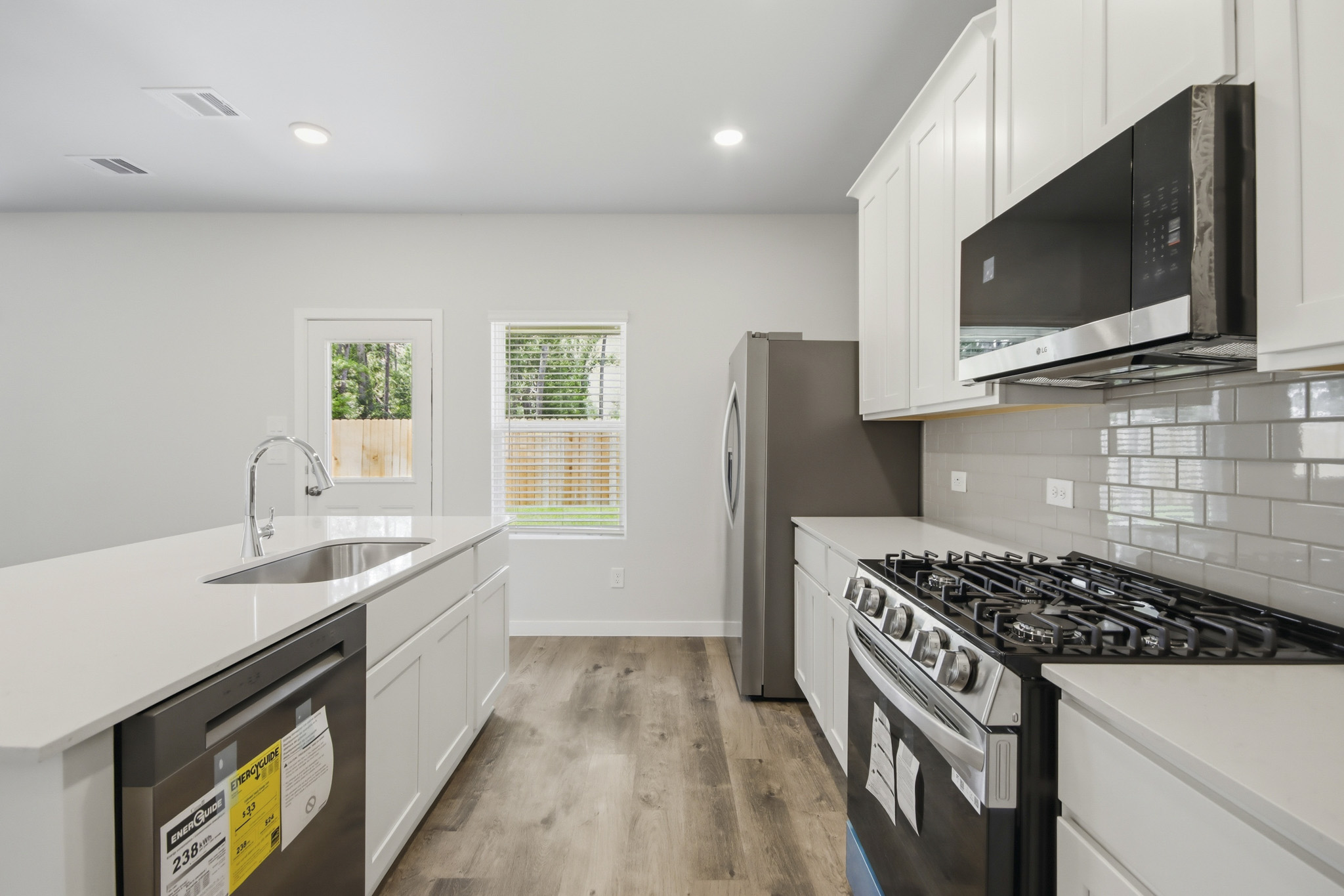 A kitchen with white cabinets.