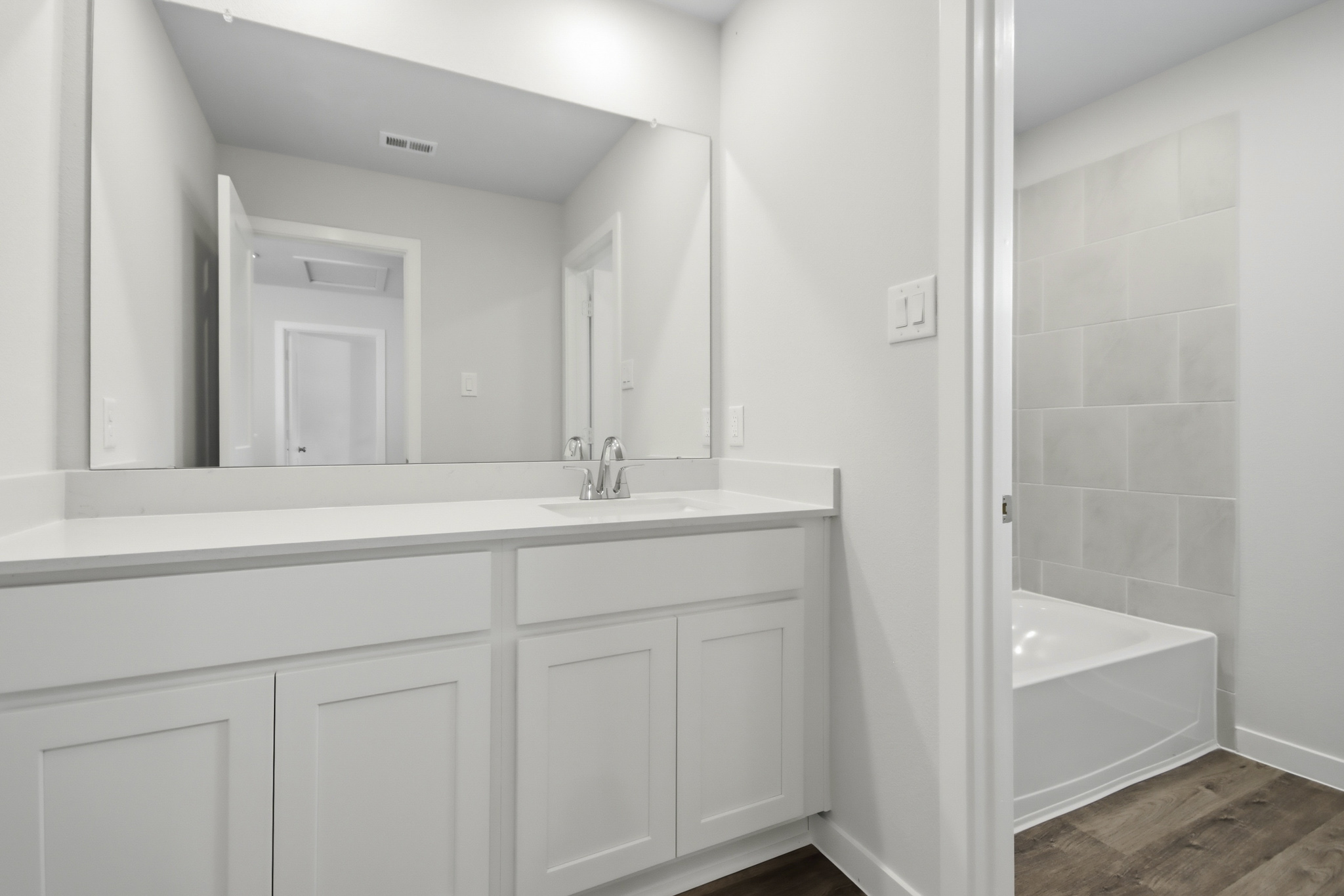 A bathroom with a sink and a bathtub.