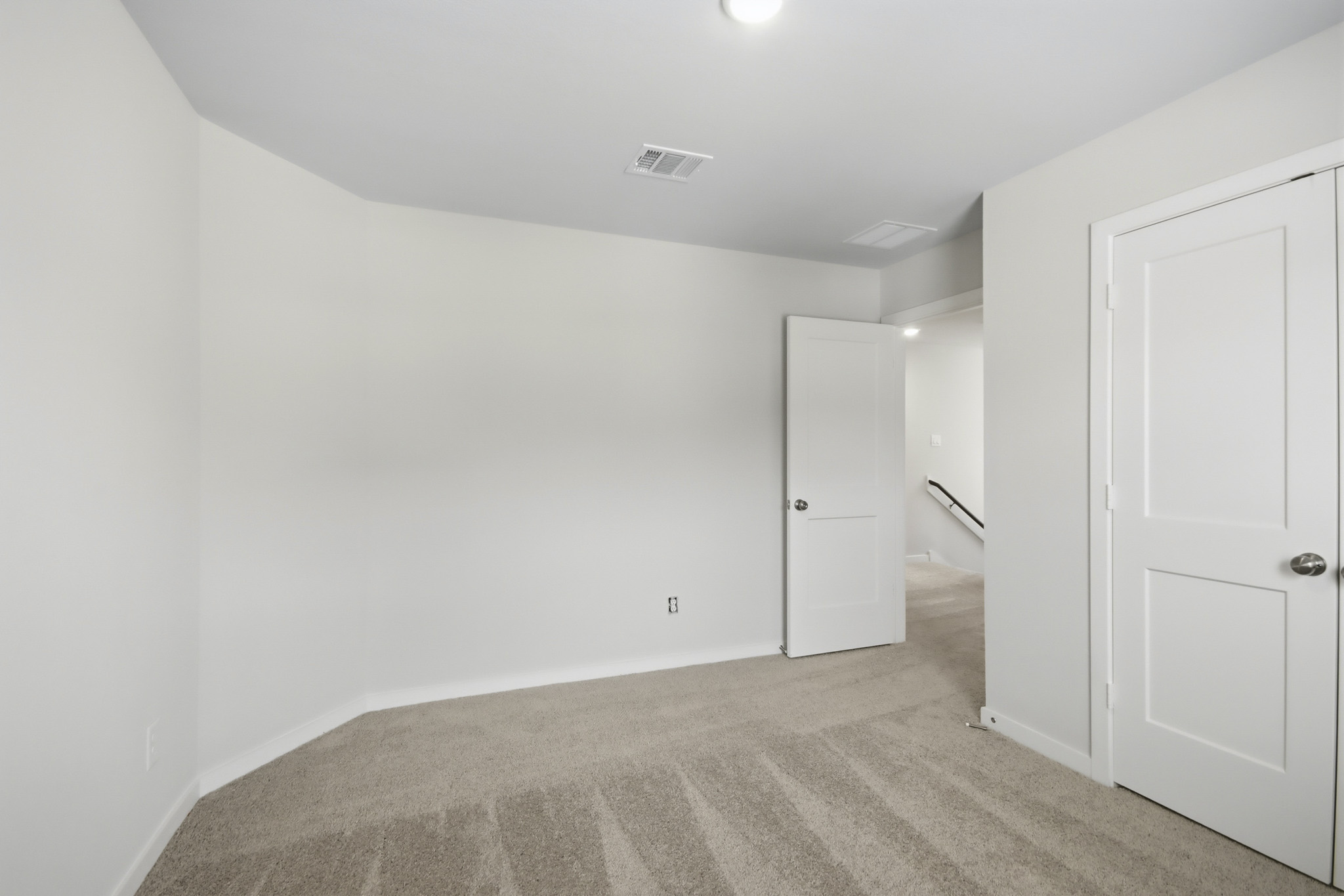 A hallway with white doors.