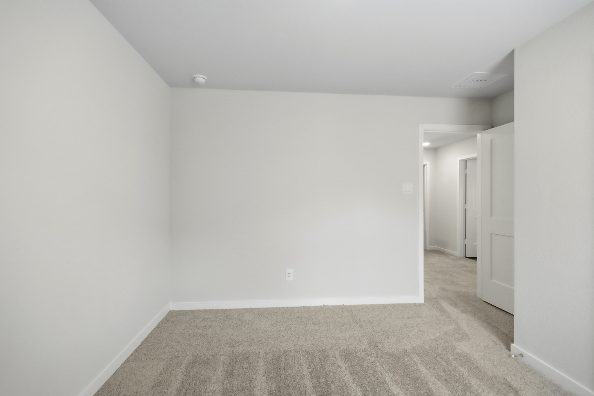 A hallway with white walls.