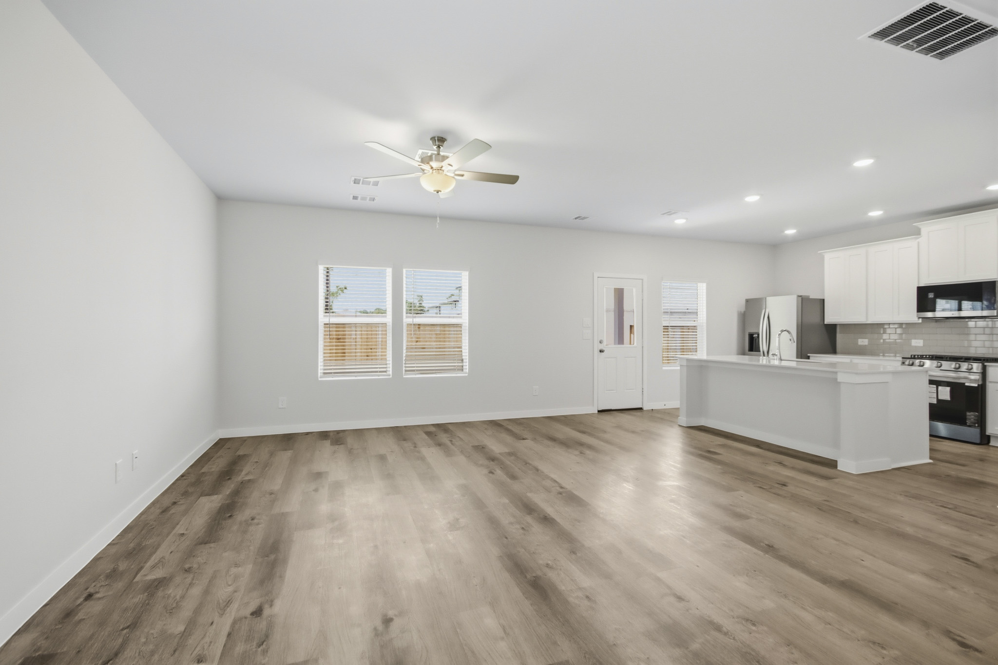 A kitchen with a wood floor.