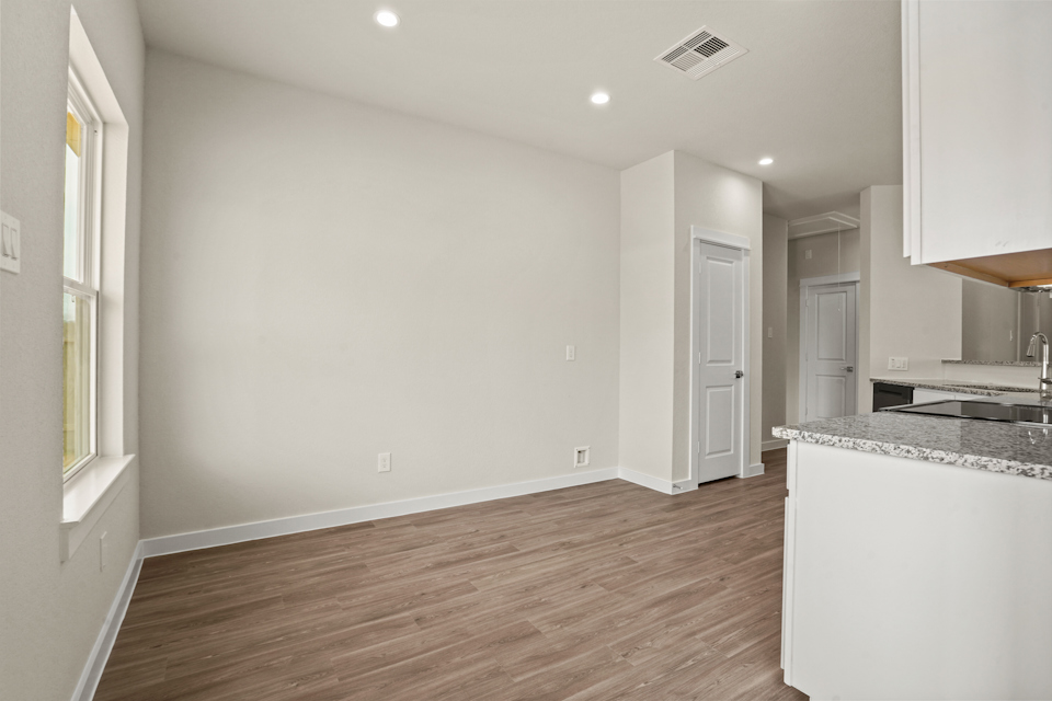 A kitchen with white walls.
