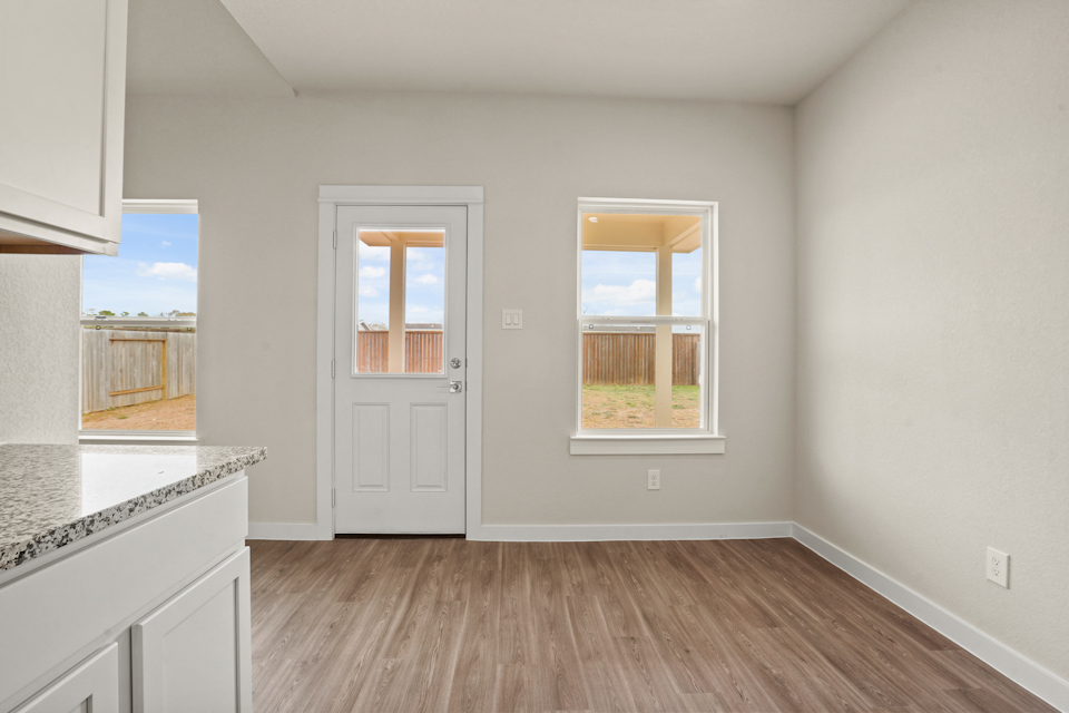 A kitchen with a wood floor.