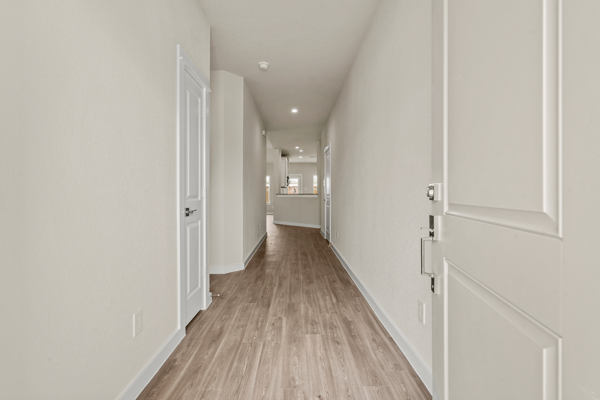 A hallway with white doors.
