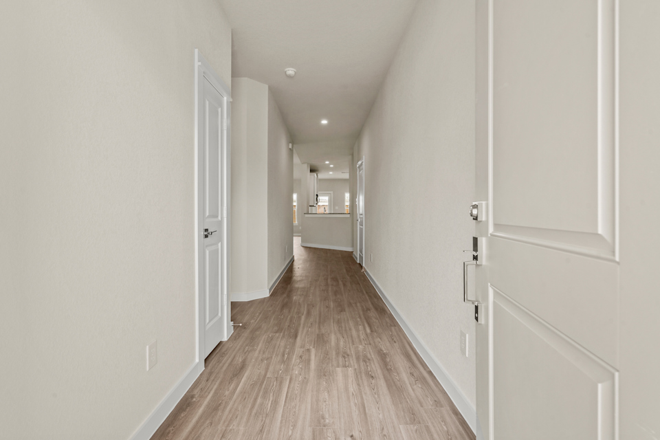 A hallway with white doors.