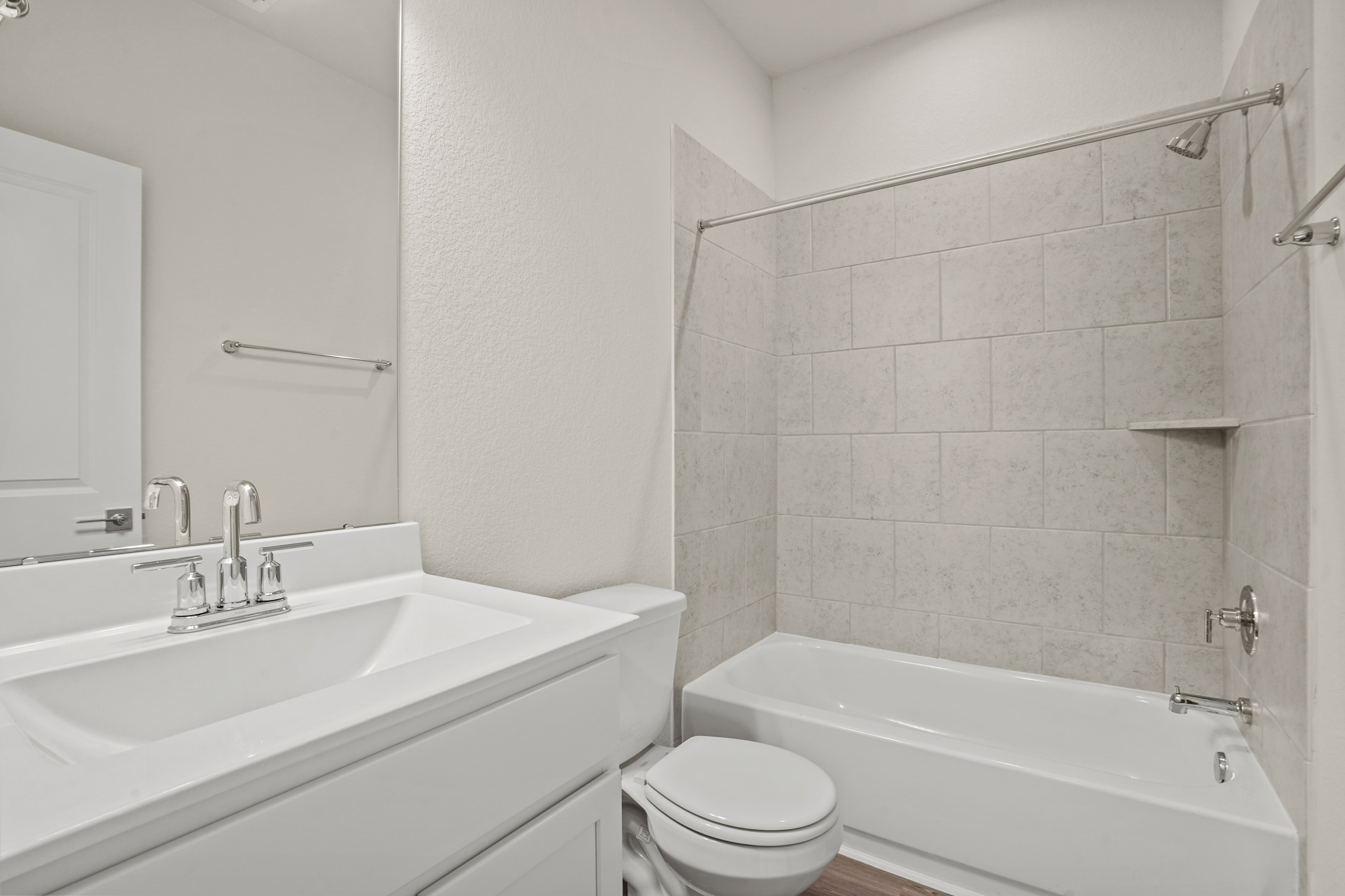 A bathroom with a tub sink and toilet.
