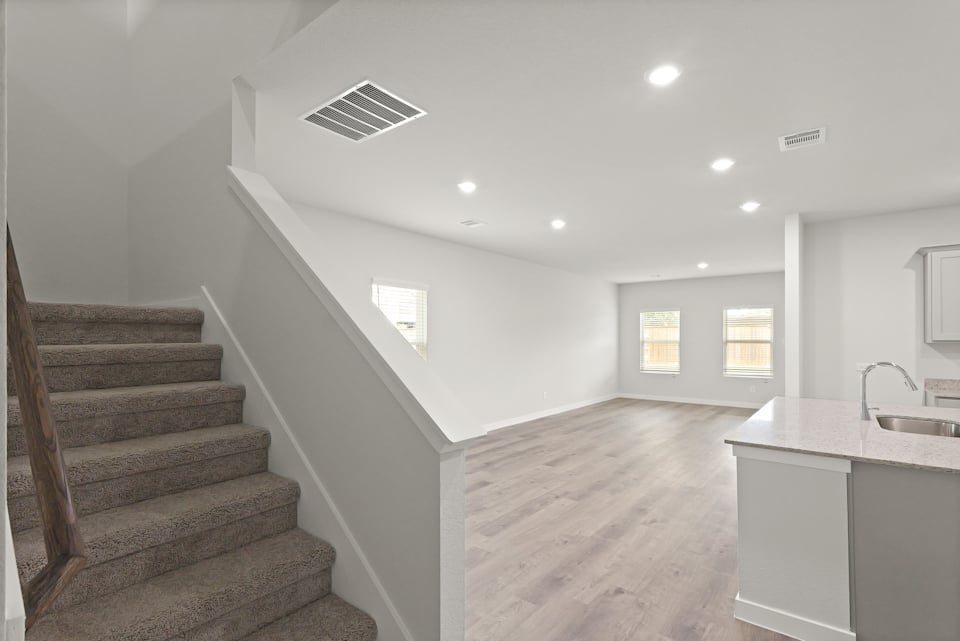A large bathroom with a staircase.