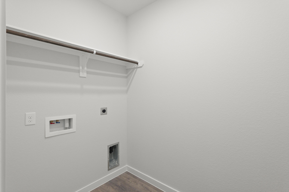 A white wall with a light fixture.